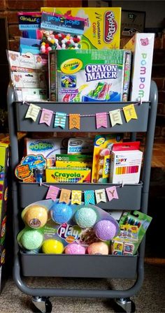 a cart filled with lots of toys on top of a carpet