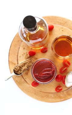 three different sauces and condiments on a wooden plate