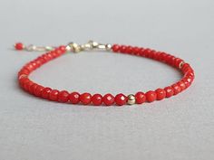 Such a delicious bracelet with vibrant genuine red coral rondelles Please measure tightly your wrist's circumference, using a ribbon or something similar, and then measuring the ribbon with a ruler. When ordering, please select the actual wrist size, not the size of the bracelet. I will make the bracelet fit your wrist, by adding approx 0.6 inch to the circumference. The bracelet was set up using  red coral rondelles and gold filled findings and it is adjustable. Available also with sterling silver findings.   Important note:  selling natural red coral is illegal. The coral used to make this product is a white coral (bamboo coral) dyed red and varnished. In time, the red color might fade, slower or faster, due to factors such as: sweat acidity, sweat/skin ph, exposure to light, exposure to Red Gemstone Jewelry, Red Coral Jewellery, Tanzanite Bracelet, Coral Bracelet, Tourmaline Bracelet, Tourmaline Jewelry, Aquamarine Jewelry, Coral Jewelry, Red Gemstones