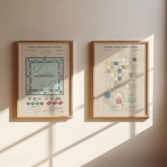 two framed maps hang on the wall next to each other