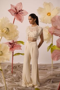 Ivory Bustier And Cepe With Pants Elevate your style with this ivory hand embroidered cepe blouse with box pleat georgette pants adorned with mesmerizing hand work. Intricate pearl and sequin create a captivating and dynamic visual effect. The heavenly embroidery reflects divine radiance, allowing you to shine brillian Flare Pants Pattern, Cape Blouse, Embroidered Cape, Pink Cape, Cape Designs, Dream Wedding Ideas Dresses, Simple Pakistani Dresses, Indian Designer Outfits