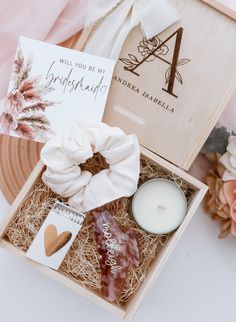 an open box containing candles, soaps and other personal care items on a table