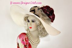 Ivory And Burgundy Wide Brim Haute Couture Designer Kentucky Derby Fashion Hat For Women. This Designer Dress Hat Is Trimmed With A Sheer Crinoline Netting Ivory Bow, Mixed With An Ivory Sinamay Straw Bow, Enhanced With A Custom Dyed Ivory And Silk Millinery Flowers. Delicate Burgundy Feathers Are Placed Behind The Flower For Added Design. This Versatile Hat Can Be Worn In Different Positions. This Feminine Hat Has Such A Romantic Feel. This Exquisite Southern Belle Hat, Is Custom Made And Designed By WomensDesignerHats.com. We Specialize In Formal Hats For Women, Custom Hats For Women, High Fashion Hats, Haute Couture Hats, Wedding Hats, Kentucky Derby Hat, Ladies Dress Hats, Church Hats, And Special Occasion Hats.

This dress hat is suited for Winter, Spring, Summer And Fall.

Material: Feminine Hat, Kentucky Derby Fashion, Special Occasion Hats, Ladies Dress Hats, Bespoke Hats, Derby Fashion, Royal Ascot Hats, Veiled Hats, Haute Couture Designers