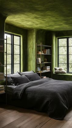 a bedroom with green walls and wooden flooring is pictured in this image, there are two large windows above the bed