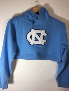 North Carolina Cropped Hoodie Team-colored Hooded Top For Game Day, Collegiate Hooded Tops For Sports Season, Casual Hooded Sweatshirt For Sports, Team-colored Hooded Top For Fan Gear, Collegiate Hooded Tops For Game Day, Fan Gear Hoodie, Team-colored Hooded Tops With Drawstring, Fall Sports Hoodie Sweatshirt, Spring Fitted Hoodie With Letter Print