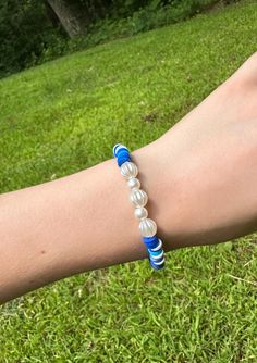 Cute blue and white beaded bracelet. These are high quality handmade bracelets. They are made with an elastic string so will fit lots of sizes. They are around 6.75 inches. Please note that each braclet will have a very similar beading pattern but not exactly identical. Blue Hand-strung Pearl Bracelet With Round Beads, Casual Adjustable Blue Pearl Bracelet, Blue Pearl Bracelet With Colorful Beads For Beach, Casual Blue Heishi Beads Stretch Bracelet, Adjustable Hand-strung Blue Pearl Bracelet, Casual Blue Pearl Bracelet With Round Beads, Bracelet Clay, Clay Beaded Bracelet, White Beaded Bracelet