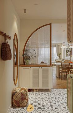 the inside of a house with an arched window and tiled flooring in front of it