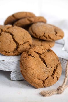 some cookies are sitting on top of a white board and tied up with twine