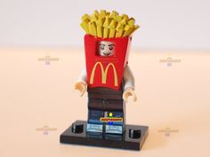 a lego figure is holding a box of fries