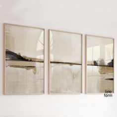 three paintings hang on the wall above a bed