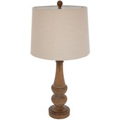 a wooden table lamp with a white shade on it's base and a beige linen lampshade