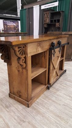 an old fashioned wooden table with two doors on the front and one door open to reveal a book shelf