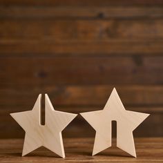 two wooden stars sitting side by side on a table