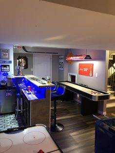 a room filled with air hockey tables and other items