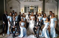 a group of people in formal wear posing for a photo