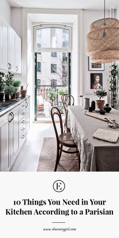 a dining room table with chairs and pictures on the wall in front of an open door