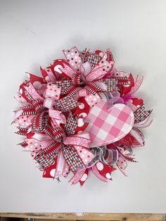 a red and white heart shaped wreath