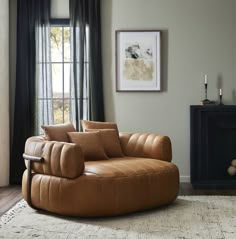 a living room with a couch, chair and rug in it's center area