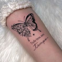 a tattoo with a butterfly and flowers on the arm that reads, tulo ten de tempa