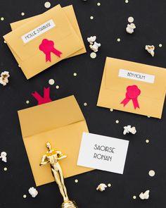 an envelope with some paper cutouts on it and popcorn scattered around the envelopes