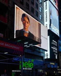 an image of a billboard on the side of a building in new york city at night