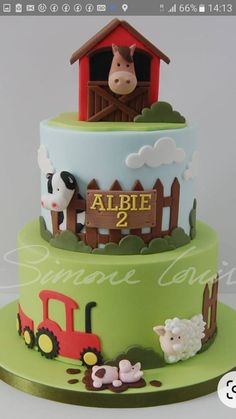 a three tier cake with farm animals on it