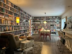 a living room filled with furniture and lots of bookshelves full of different types of books