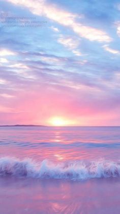 the sun is setting over the ocean with waves coming in to shore and pink clouds