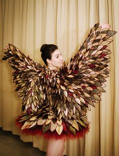 a woman in a dress made out of leaves