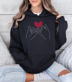 "- **Couple Valentines Day Hoodie - \"Pinky Promise\"** - **Material Composition   - Made with a thick blend of cotton and polyester for a plush, soft, and warm feel.   - Medium-heavy fabric (8.0 oz/yd² or 271 g/m²) consisting of 50% cotton and 50% polyester, providing the ideal cozy warmth for chilly days. - **Design Features   - Spacious kangaroo pocket in the front for daily practicality.   - Hood's drawstring is color-matched to the base sweater, adding extra style points. - **Comfortable Fit   - Classic fit for comfort.   - Pouch pocket and tear-away label contribute to a highly comfortable, scratch-free wearing experience. - **Stylish Details   - Color-matched drawcord enhances the overall aesthetic.   - Double-lined hood for added style and durability. - **Ethical Manufacturing   - Casual Hooded Sweatshirt For Valentine's Day, Valentine's Day Casual Hoodie With Letter Print, Cotton Crew Neck Hoodie For Valentine's Day, Valentines Day Hoodie, Couple Valentines Day, Valentines Day Sweatshirt, Pinky Promise, Couples Hoodies, Cozy Gift