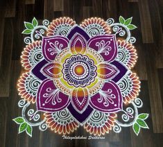 a colorful flower design on a wooden floor