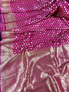 Pink Handloom Banarasi Silk Saree with Grand Pallu. SmalButtis all over the body of the Saree with Grand Pallu. Item : Saree Color : Pink Base Fabric : Banarasi Silk Blouse piece : Comes with Blouse piece Blouse material : Banarasi Silk Fall & Edging: Comes with Fall and edging (Pico) and tassels attached Occasion: Party, Wedding, Festival, Wedding, Traditional, Religious, House-warming, Social Gatherings and Celebrations. Please note- Color might slightly vary due to lighting and camera. Ki Festival Celebration Banarasi Silk Sharara, Celebration Katan Silk Saree With Motifs, Traditional Wear With Zari Weaving For Celebrations, Eid Celebration Choli With Zari Weaving, Banarasi Silk Sharara With Pallu For Celebrations, Brocade Saree For Festive Celebrations, Brocade Saree For Festivals And Celebrations, Brocade Saree For Celebrations And Festivals, Banarasi Silk Choli With Zari Weaving For Celebration