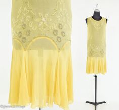 "~ 1920s pale yellow silk chiffon flapper dress ~ Decorated with silver, clear and pearl glass beads flowers ~ Hand set rhinestones ~ Scoop neckline ~ Scalloped drop waist ~ Sleeveless ~ Spots here & there ~ 1 small hole on left shoulder ~ Sold as is... ~ Very nice however Bust- 33\" (83.82 cm) Shoulders- 12.5\" (31.75 cm) Waist- 26\"  (66.04 cm) Hips- 30\"  (76.2 cm) Length-28\"  (71.12 cm) More Incredible Vintage: http://glennasvintageshop.etsy.com Vintage Jewelry:  http://glennasjewels.etsy.c Summer Knee-length Gatsby Flapper Dress, Summer Knee-length Flapper Dress, Yellow 1920s Dress, Knee-length Vintage Flapper Party Dress, 1920s Cream Summer Dress, Silk Yellow Dress, 20s Dresses, Buttercup Yellow, Drop Waist