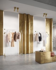 a clothing store with gold and white walls