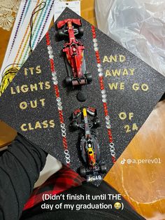 a graduation cap that has cars on it