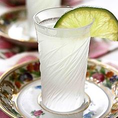 a white glass with a lime slice on it