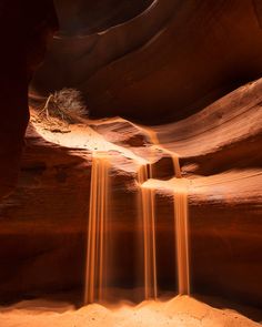 an image of a waterfall in the middle of a desert area with light coming from it