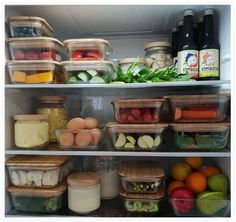 an open refrigerator filled with lots of different types of food and drinks in plastic containers