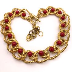 A fabulous Vintage 1980s Kenneth J Lane gold chain necklace, large and chunky with red cabochon stones. Excellent vintage condition. Gold plating in excellent condition. Width of the chain links are 3cm x 2cm  The stones are 1cm diameter. The bar closure has Kenneth Lane impressed on it. Any postage overages will be refunded. Heavy Chain Necklace, Heavy Chain, Art Deco Necklace, Necklace Design, Chain Links, Red Stone, Gold Chain Necklace, Necklace Designs, Gold Plating