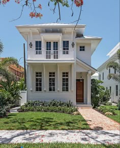 a white two story house with lots of windows