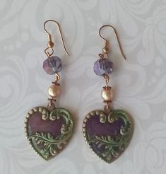 Heart Earrings with Painted vintage brass heart purple czeck crystals and pearl These earrings can go from dress up to casual look for lunch and/or drinks with the girls and lets not forget date night. Dress these earrings  up or down with a causal button down top. Earring length is 3 inches. Vintage Dangle Heart Beads Jewelry, Vintage Dangle Jewelry With Heart Beads, Vintage Jewelry With Heart Beads And Dangle Shape, Purple Heart Beads Jewelry For Party, Vintage Metal Heart Earrings, Handmade Vintage Metal Heart Earrings, Vintage Heart-shaped Earrings For Party, Vintage Heart Charm Earrings For Wedding, Handmade Vintage Heart Earrings