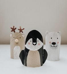 three paper animals are standing next to each other