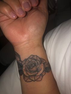 a woman's arm with a rose tattoo on it