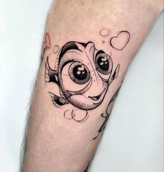 a close up of a person's leg with an eyeball tattoo on it