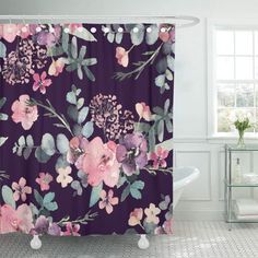 a purple shower curtain with pink and blue flowers on it next to a bathtub