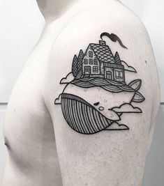 a man's shoulder with a house and waves tattoo on the left side of his arm