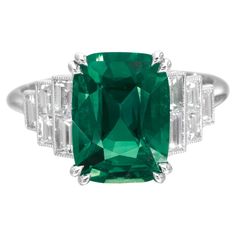 Experience unparalleled sophistication with our AGL-certified Cushion Cut Natural Emerald Ring, where timeless beauty meets modern allure. The ring features a stunning 5-carat Cushion Cut Emerald as its centerpiece, exuding unmatched grace. Accentuating its elegance are emerald Cut diamonds as side stones, totaling 2 carats, which add a touch of brilliance and glamour. Expertly crafted in platinum, this ring perfectly blends opulence with contemporary style is a true masterpiece—a symbol of refi Colombian Emerald Ring, Natural Emerald Rings, Emerald Cut Diamond Ring, Vintage Cocktail Ring, Baguette Diamond Rings, Bracelet Love, Platinum Diamond Rings, Emerald Cut Rings, Emerald Diamond Ring