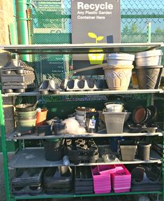 a green shelf filled with lots of pots and other items