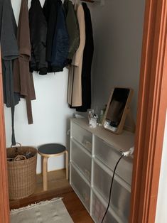 an open closet with clothes hanging on the wall and a phone hooked up to it