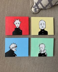 four coasters with cartoon characters painted on them sitting on a couch next to a pillow